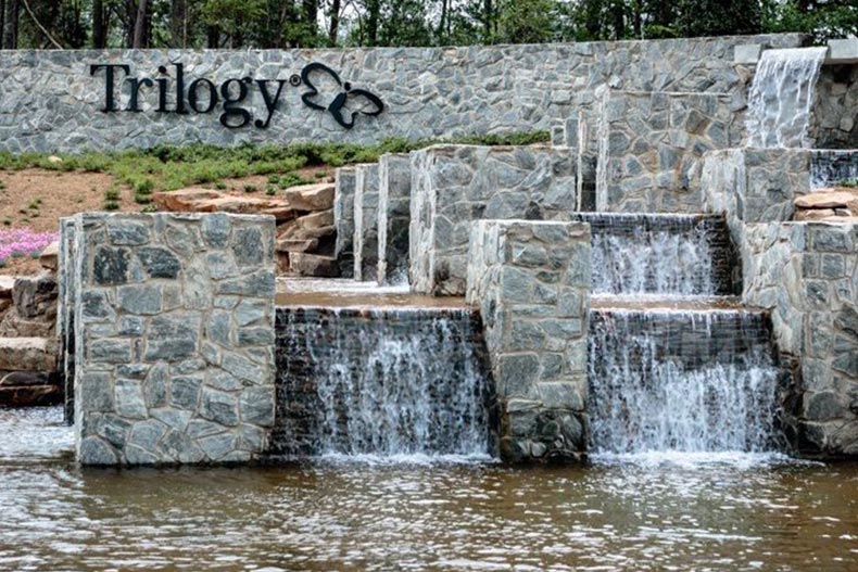 A water feature beside the community sign for Trilogy Lake Norman in Denver, North Carolina.