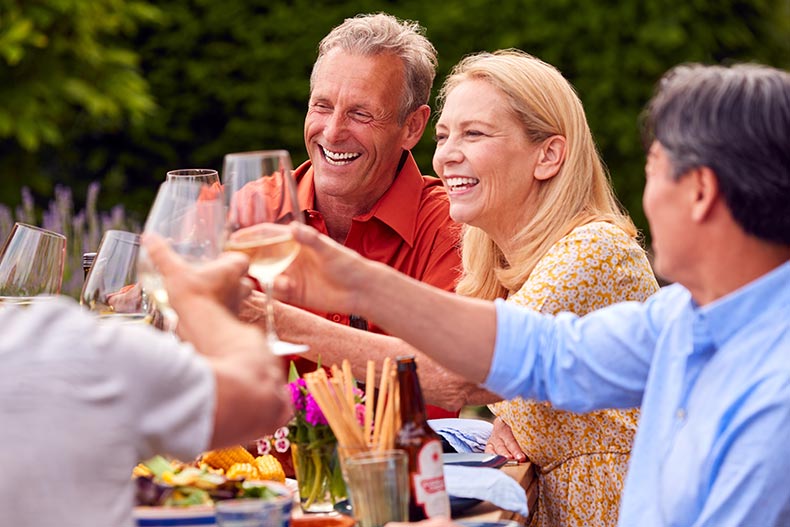 A group of neighbors having dinner outside in their 55+ community.