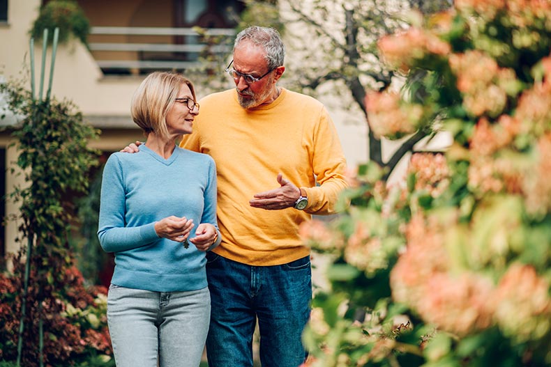 A retired couple with the keys to their new home in a 55+ community.