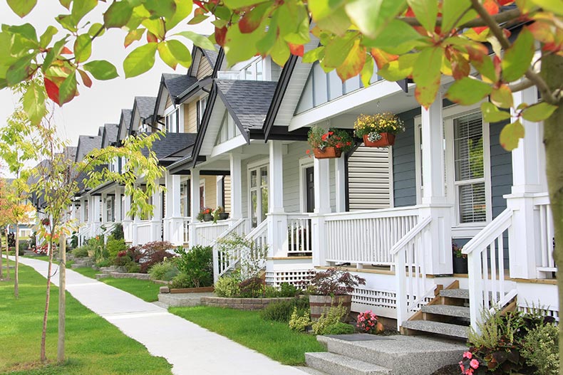 A friendly neighborhood with porches and a sidewalk.