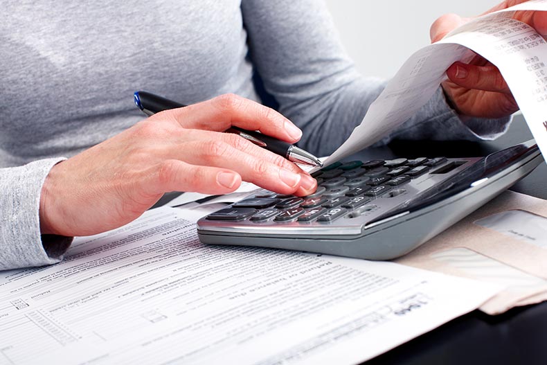 A 55+ woman working on Form 1040 for her taxes.