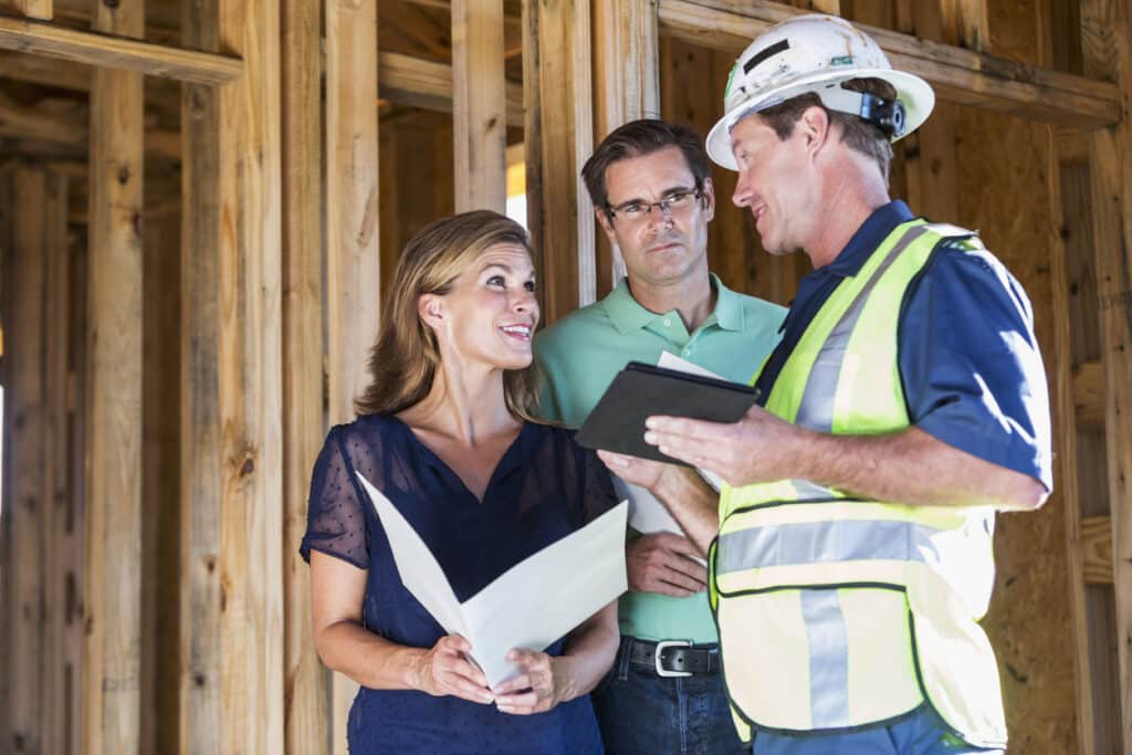 55+ homebuyers discuss plans with their builder in Phoenix.