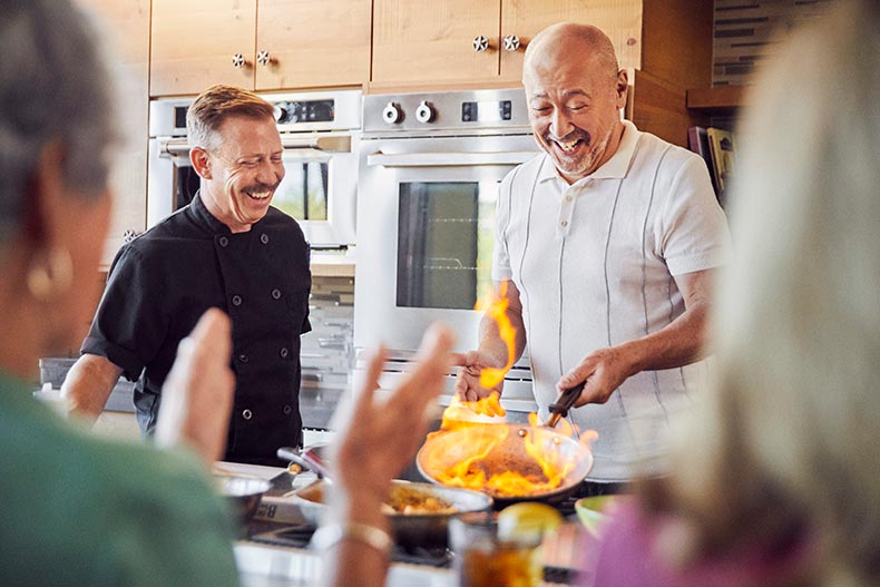 Active adult enjoying a cooking demonstration in their 55+ community.