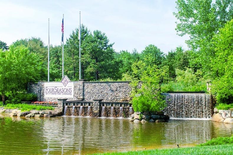 A pond in front of the community sign for Four Seasons at Lakewood in Lakewood, New Jersey.