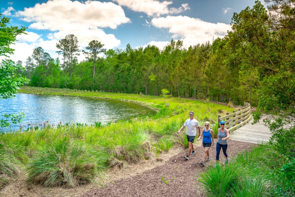 Active adult residents taking a walk on the nature trail in their 55+ community.