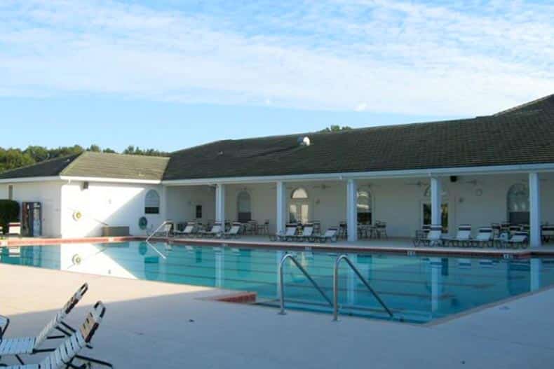 Lounge chairs beside the outdoor pool at Ocala Palms in Ocala, Florida.