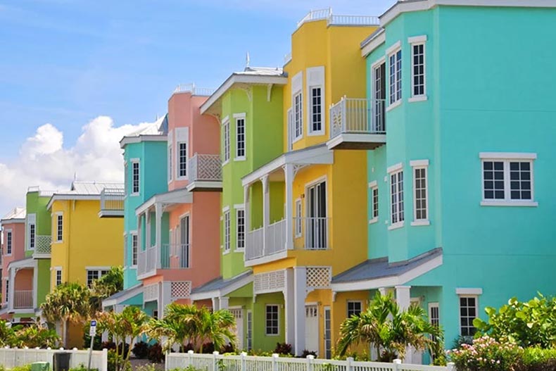 A row of colorful 55+ rental properties in a tropical location.