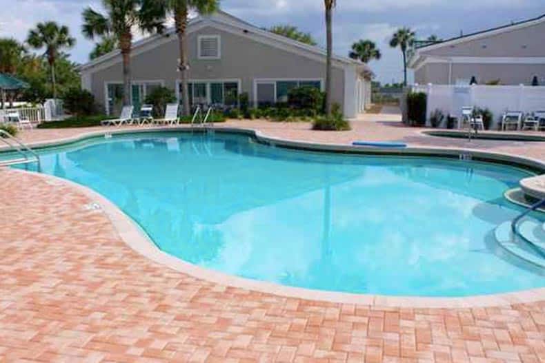 Lounge chairs and palm trees surrounding the outdoor pool at Stonecrest in Summerfield, Florida.