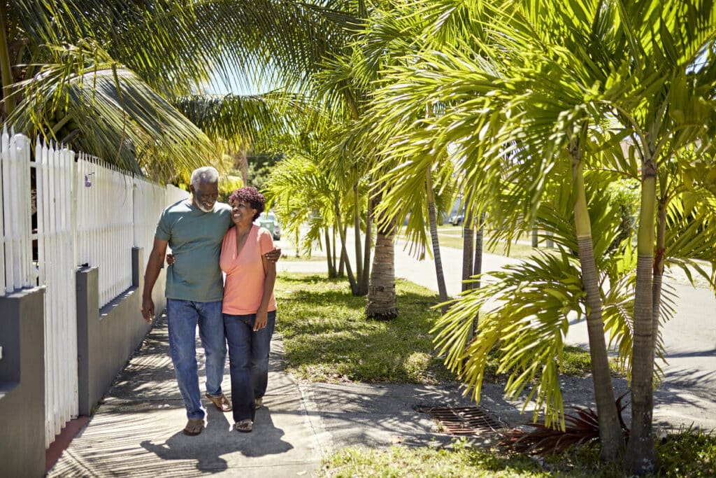 Retired couple walks a Florida street.
