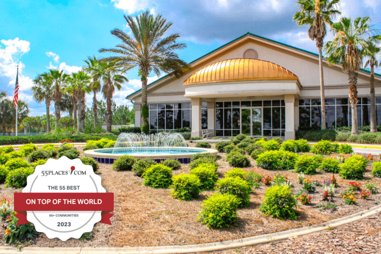 "The 55 Best 55+ Communities" badge over an exterior view of a clubhouse on the grounds of On Top of the World in Ocala, Florida.