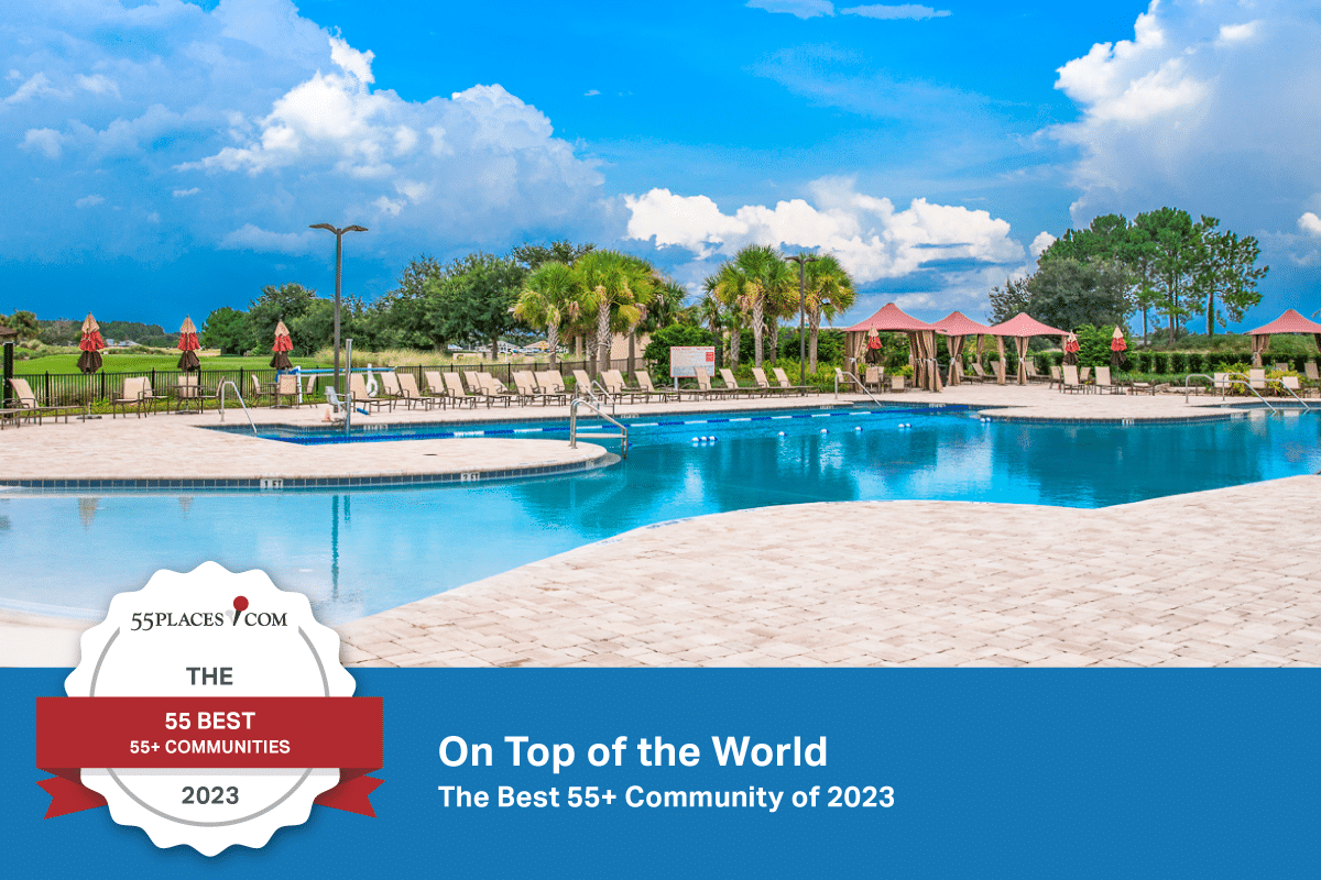 "The 55 Best 55+ Communities" badge over the outdoor resort-style pool at On Top of the World in Ocala, Florida.