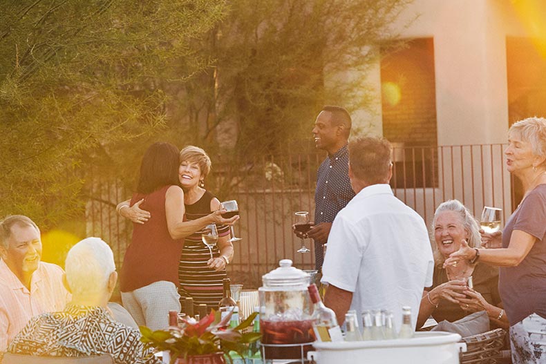 Neighbors having an outdoor party in a 55+ community.