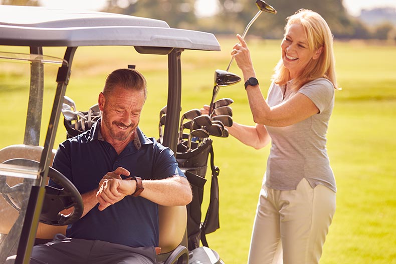 A 55+ couple playing golf in Arizona.