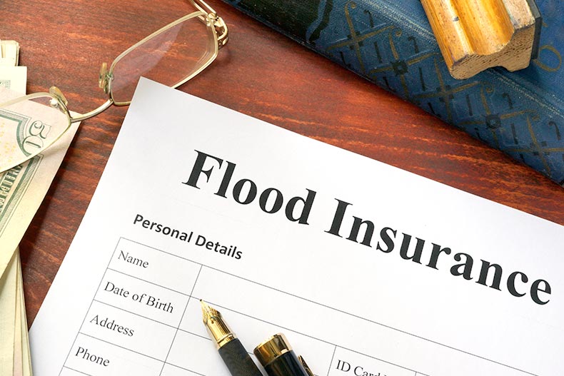 A sample flood insurance document on a wood desk.