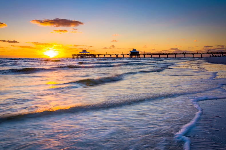 Sunset over the fishing pier and Gulf of Mexico in Fort Myers Beach, Florida.