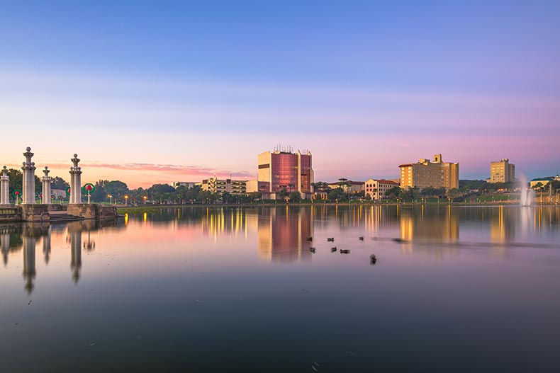 View across the water of the downtown cityscape of Lakeland, Florida at twilight.
