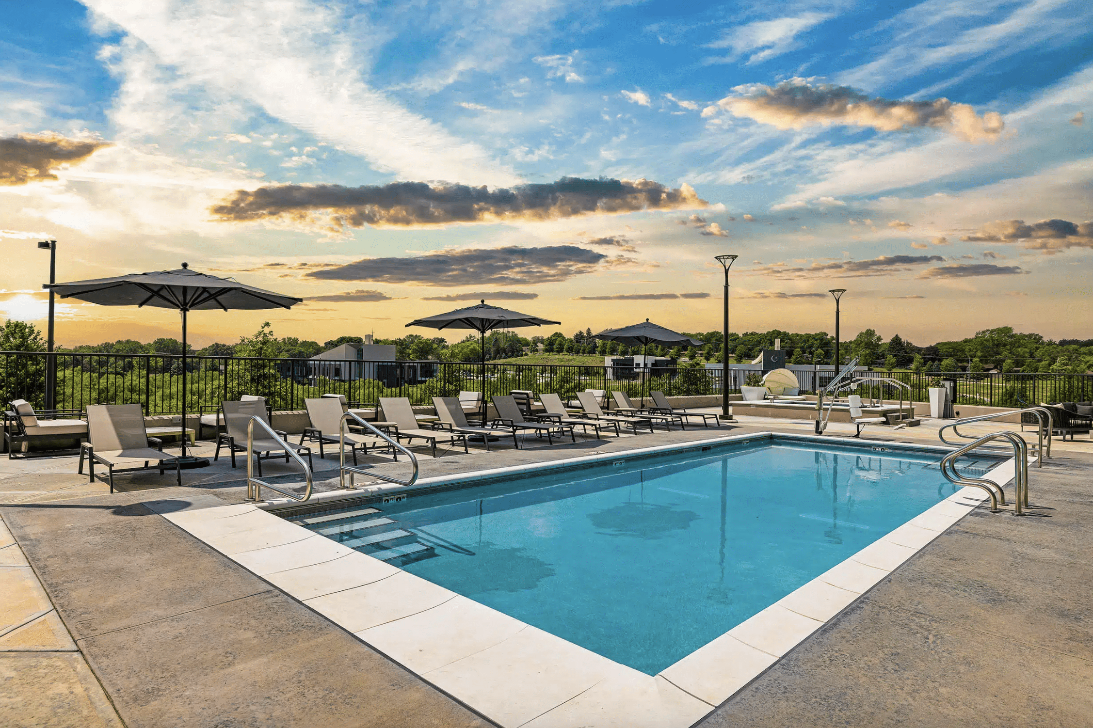 Lounge chairs surrounding the outdoor pool at Avidor Omaha in Omaha, Nebraska.