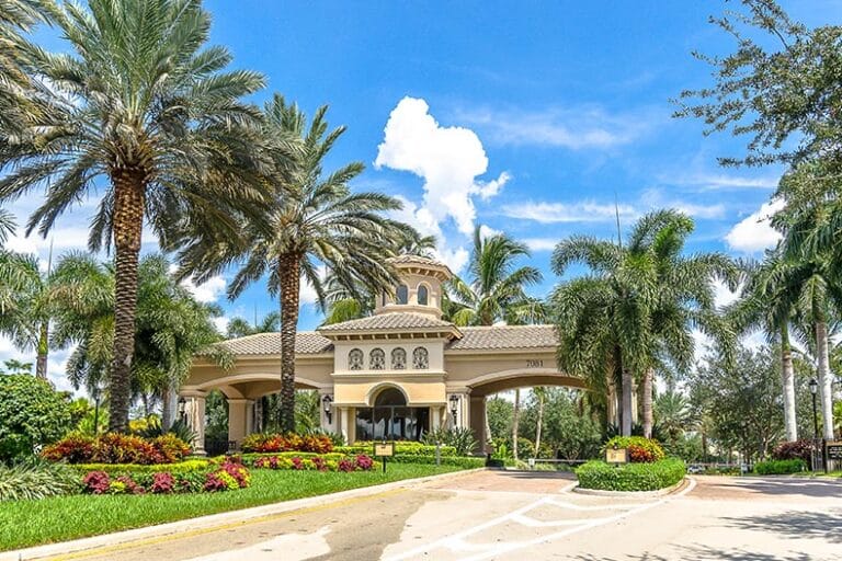 Palm trees beside the gated entrance of Valencia Pointe in Boynton Beach, Florida.