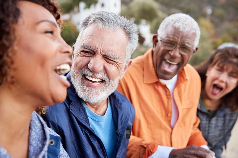 A group of senior friends talking and laughing.