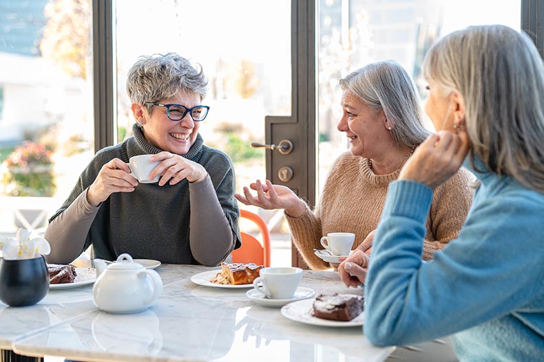 A group of 55+ women having fun during breakfast.