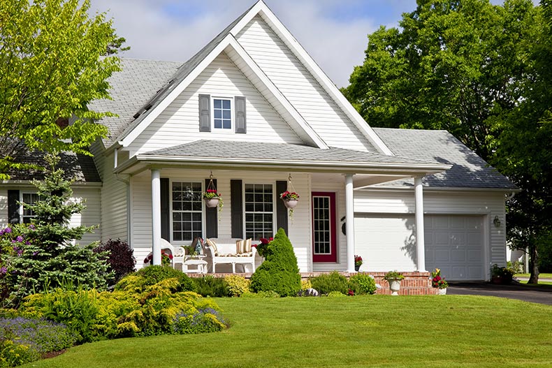 Exterior view of a cozy white house in a gated 55+ community.