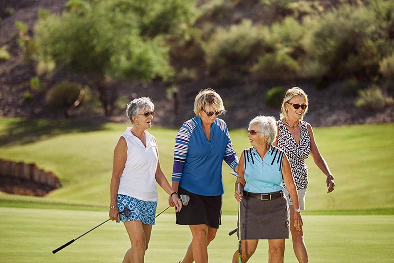 A group of female friends playing golf in their 55+ community.