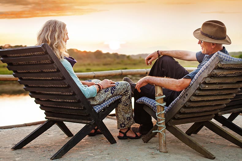 A senior couple sitting on chairs in Chitwan National Park in Nepal.