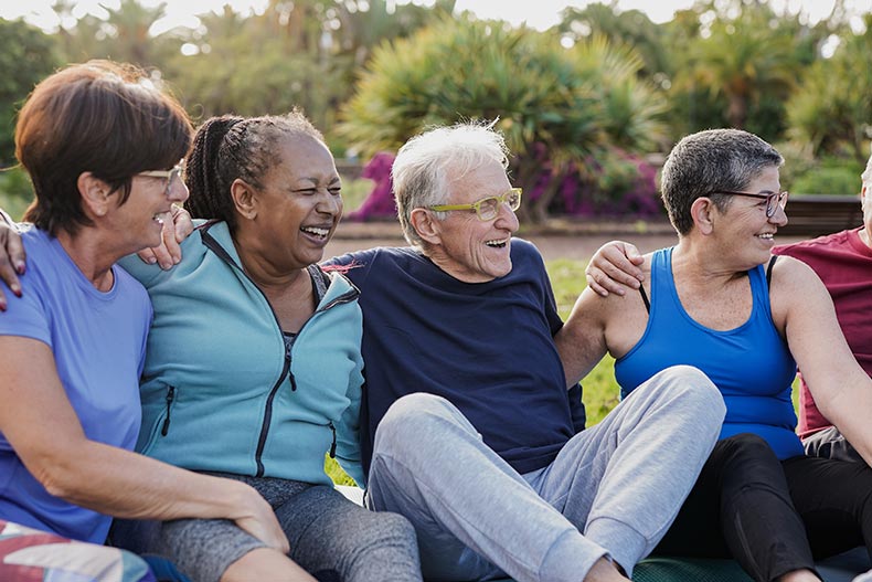 Friends having fun together after yoga exercise class in a 55+ community.