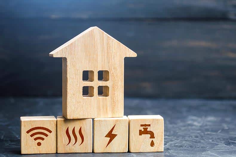 Wooden blocks depicting a house and home utilities.