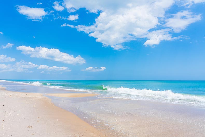 A sandy beach on a sunny day in Melbourne Beach, Florida.