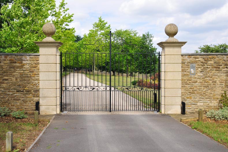 The gates and driveway of a country estate.