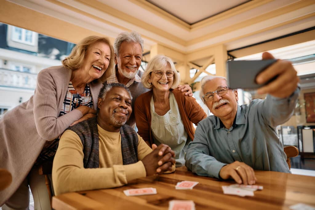 A group of retirees take selfie in their retirement community.