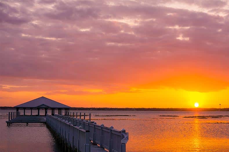 A sunset over a pier on Lake Jackson in Sebring, Florida.