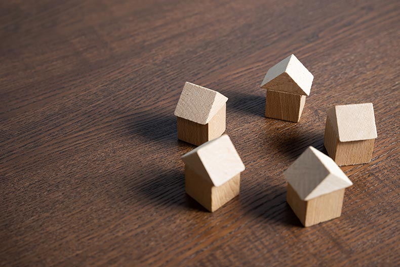 A circle of small wooden houses.