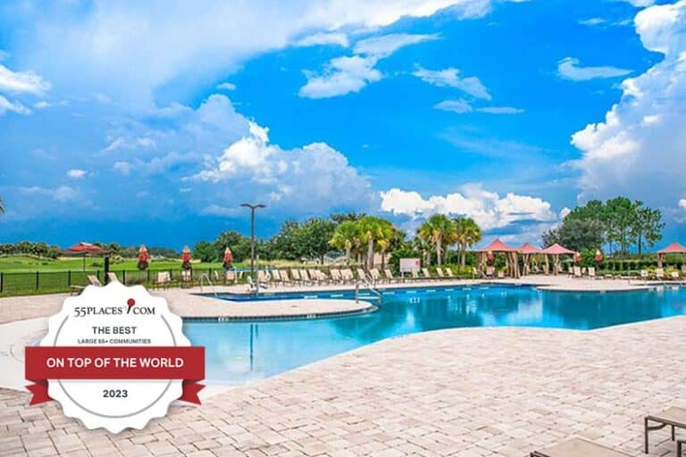 Award badge over an outdoor, resort-style pool at On Top of the World in Ocala, Florida.