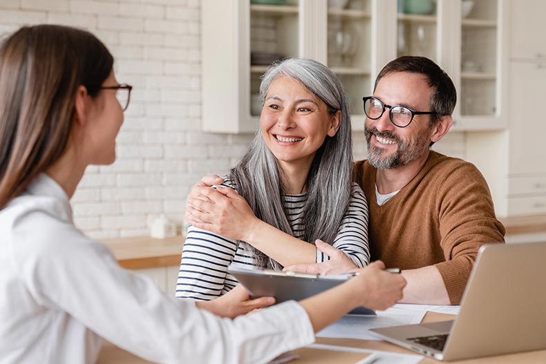 A real estate agent answering 55+ home buying questions for a retired couple.