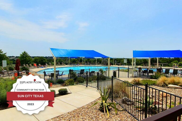 "Community of the Year" badge over the pool at Sun City Texas in Georgetown, Texas.