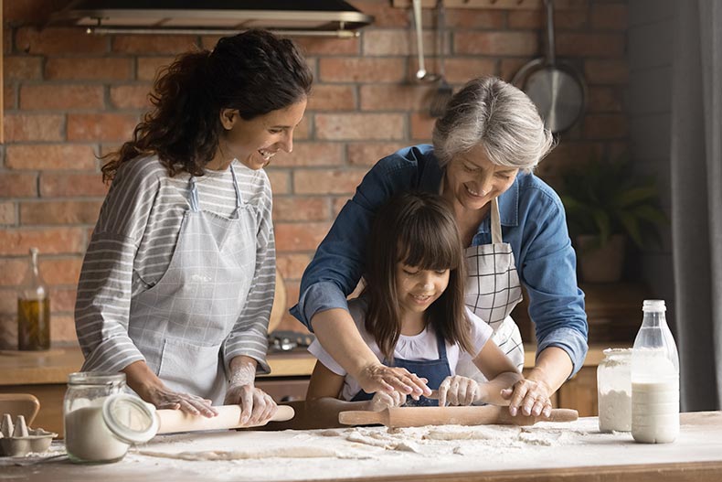 A 55+ grandma baking with her daughter and granddaughter.