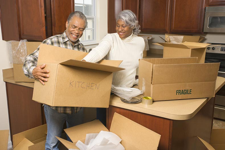 A 55+ couple packing up their kitchen as they get ready to move.