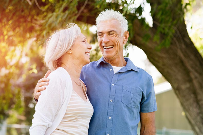 A senior couple relaxing in a park in their 55+ community.