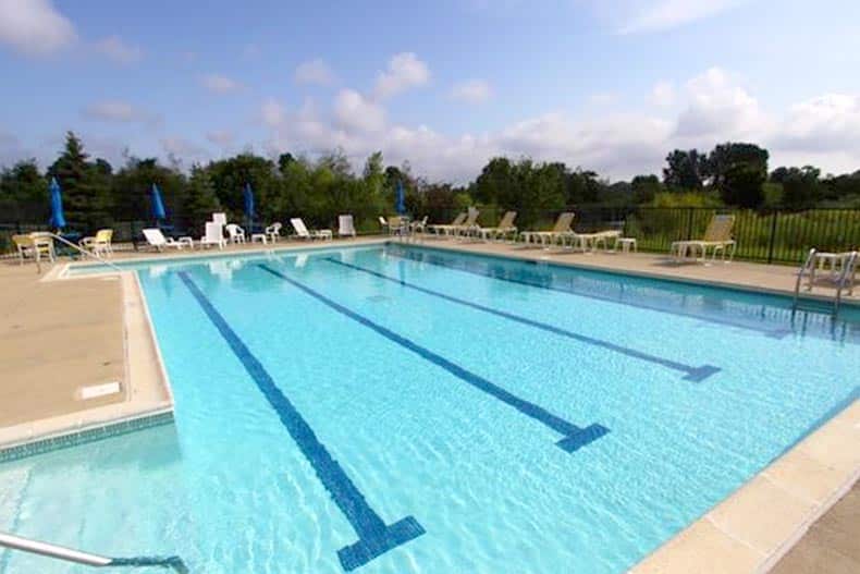 Chairs surrounding the outdoor pool at Carillon at Heatherstone in Beach Park, Illinois.