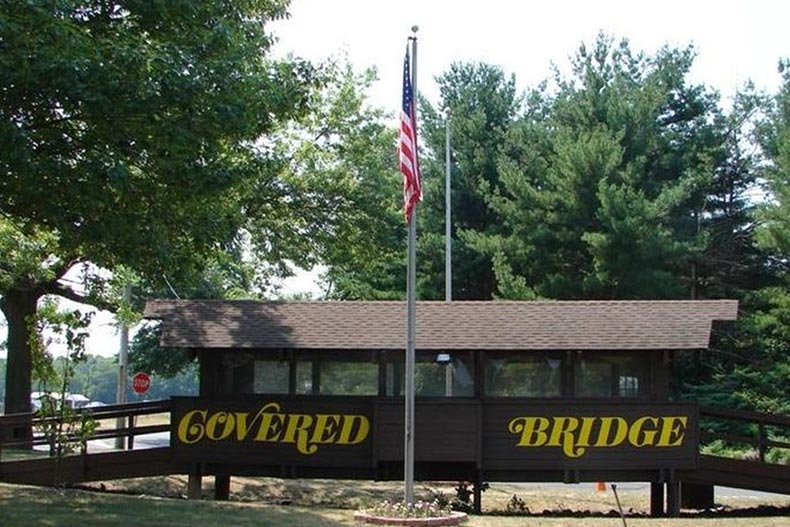 The community sign for Covered Bridge, one of many NJ 55+ communities.