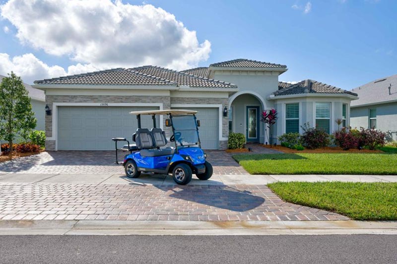 A golf cart outside a home at Del Webb Tradition in Port St. Lucie, Florida.