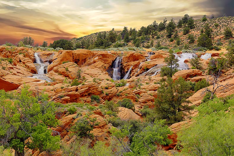 Waterfalls flowing over the red rock at Gunlock State Park in Utah.