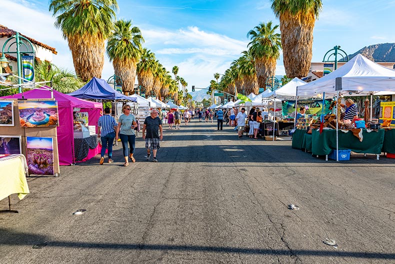 People enjoying the vendors and entertainers at the Palm Springs Street Fair.