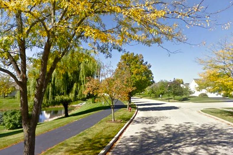 A paved walkway on the grounds of River Run Club in Oswego, one of many Illinois 55+ communities.