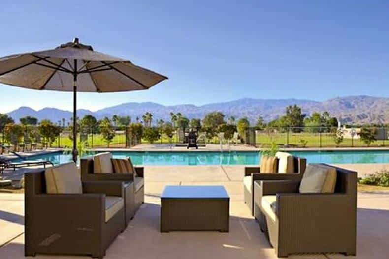 Lounge chairs beside the outdoor pool at Villa Portofino in Palm Desert, California.