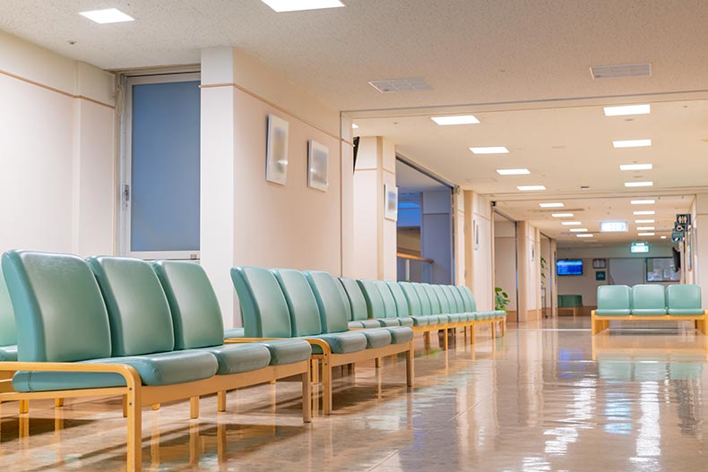 Chairs lined up in a hospital waiting room.