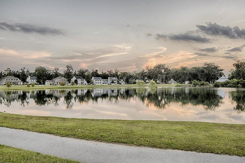 Homes across a pond at Cottages at Autumn Lake, an active adult community worth considering for homebuyers moving to Savannah, GA.