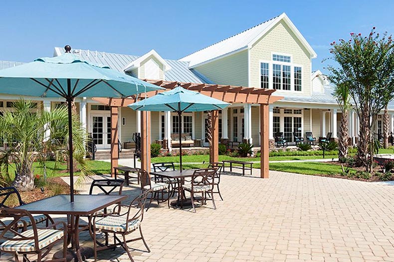 Tables and chairs on the outdoor patio at Cresswind Myrtle Beach in Myrtle Beach, South Carolina.